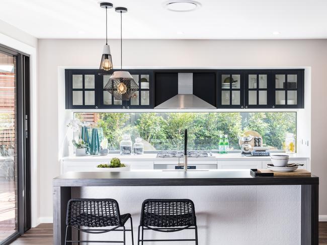 A glass splashback gives the open-plan living space a strong connection to the garden.