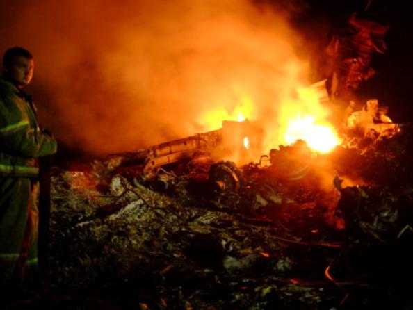 A firefighter stands as flames burst amongst the wreckages of the malaysian airliner carrying 298 people from Amsterdam to Kuala Lumpur after it crashed, near the town of Shaktarsk, in rebel-held east Ukraine, on July 17, 2014. There were 298 people, including 154 Dutch nationals, on board the Malaysia Airlines flight that crashed in strife-torn eastern Ukraine on Thursday, an official from the carrier said. AFP PHOTO/DOMINIQUE FAGET (Photo credit should read DOMINIQUE FAGET/AFP/Getty Images)