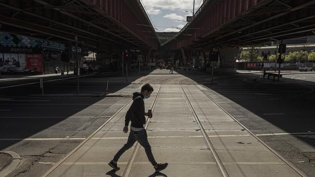 A person wearing a mask is seen exercising in South Melbourne. Picture: Getty Images