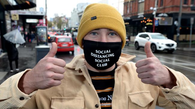 Callum Charles walks along Chapel St in his mask after the recent spike in COVID-19 cases. Picture: Andrew Henshaw