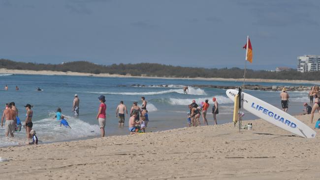 A Brisbane family man was taken to hospital after he swallowed water while being stuck in a rip at Kings Beach.