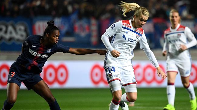 Lyon's Norwegian forward Ada Hegerberg (C) vies with Paris Saint-Germain's Brazilian defender Daiane last month.