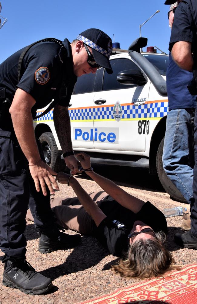 A 63-year-old woman is handcuffed by police. Picture: Sierra Haigh