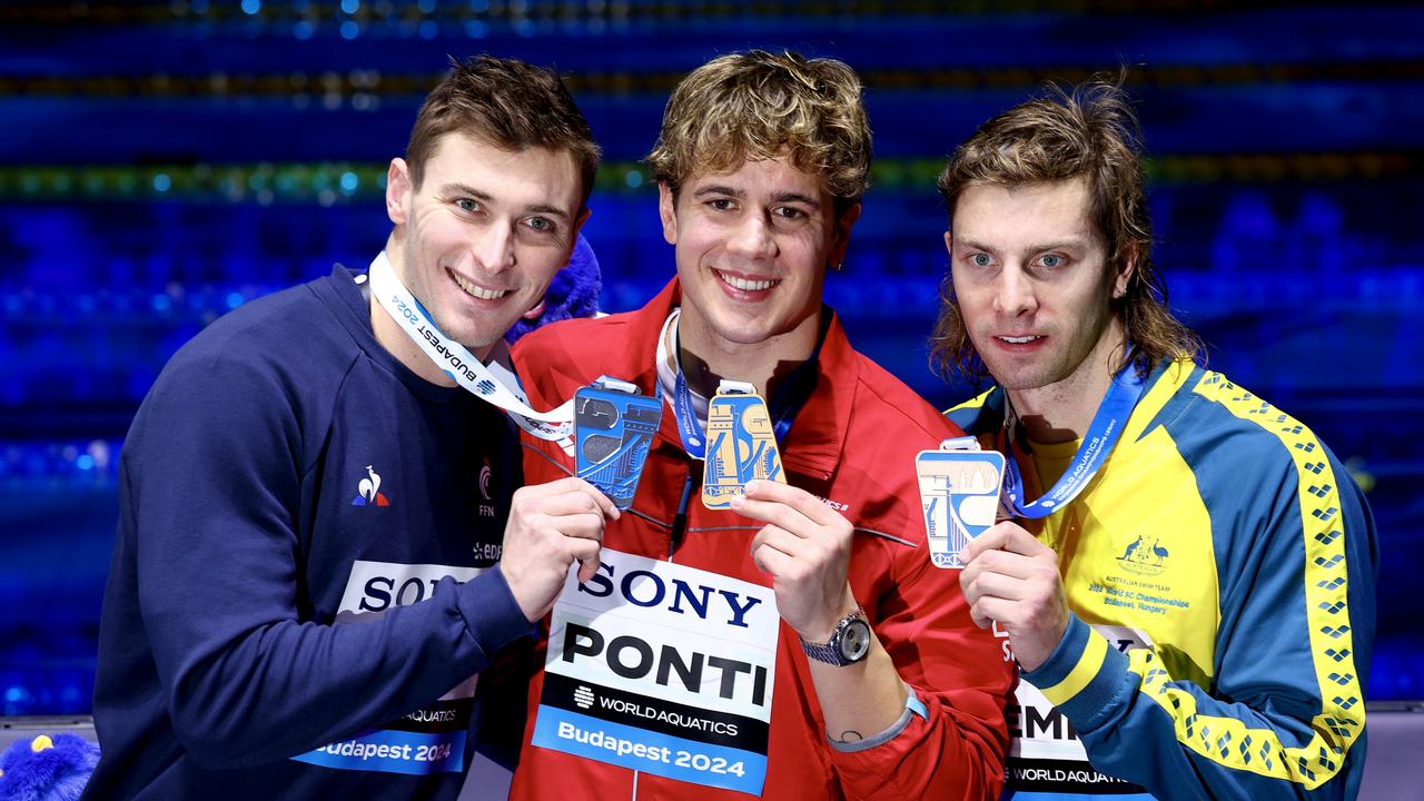 Noe Ponti with France’s silver medalist Mazime Grousset and bronze medalist Matthew Temple after the 100m butterfly. (Photo by Dean Mouhtaropoulos/Getty Images)