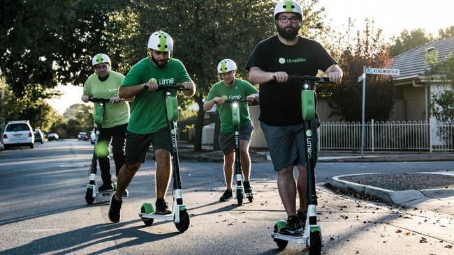 Lime Scooter staff Tim Kelly, Ali Bayati, Zak Bishop and Jeff Roberts outside the Lime warehouse on Sunday. Picture: AAP / Morgan Sette