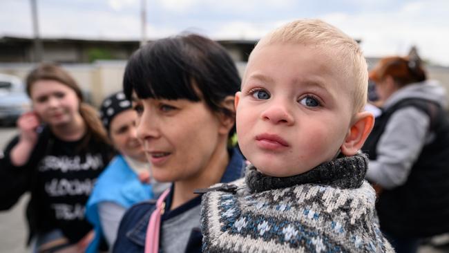 Alexey Dulai is held by his mother Natalia Dulai as they wait to board a coach destined for Przemysl in Poland, carrying refugees from regions of Southern and Eastern Ukraine. Picture: Getty Images