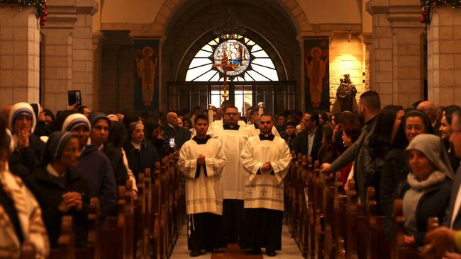 Worshippers attend Christmas morning mass at the Saint Catherine's Church, in the Church of the Nativity in Bethlehem, in the Israeli-occupied West Bank.