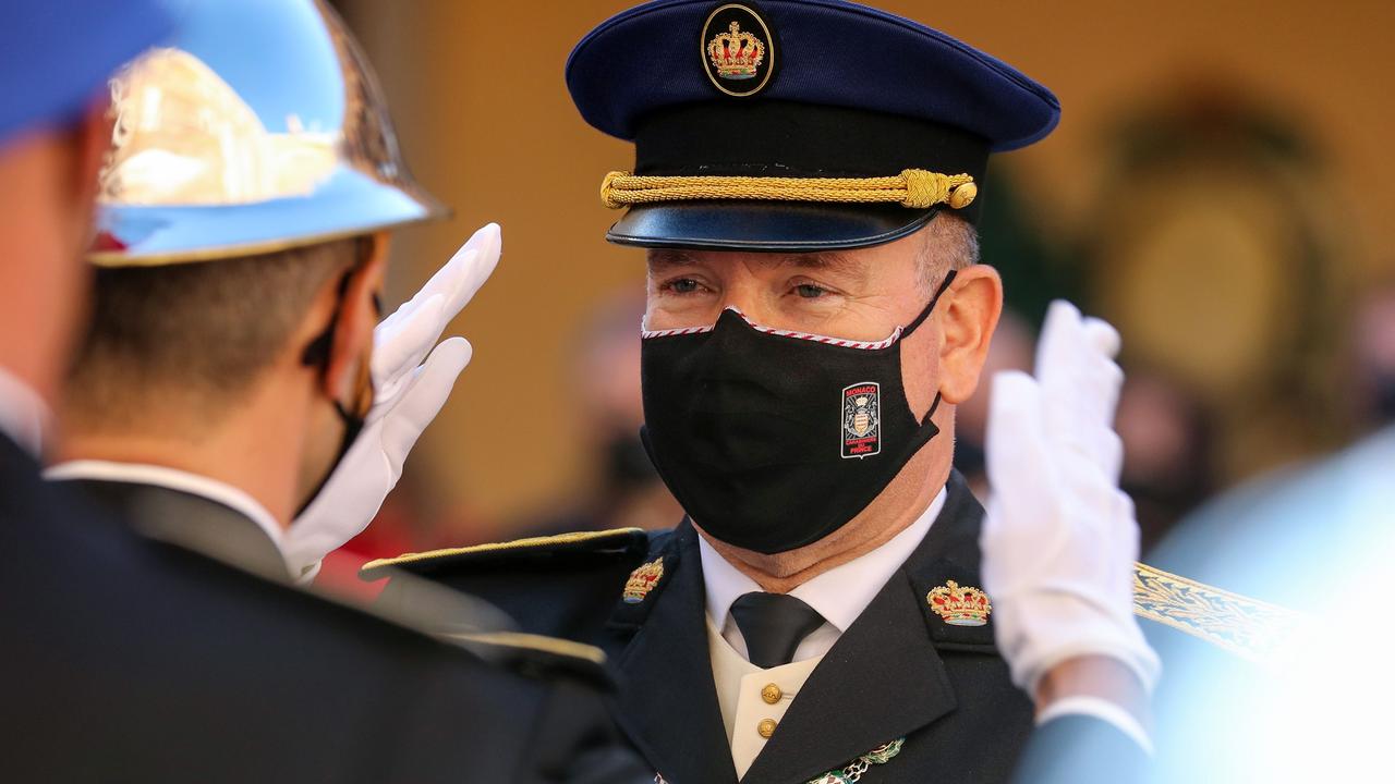 A masked Prince Albert II of Monaco salutes in November. Picture: Valery HACHE / POOL / AFP