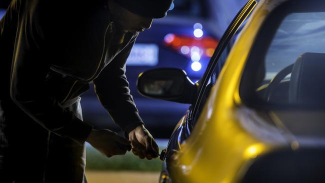 Car thief stealing a car.