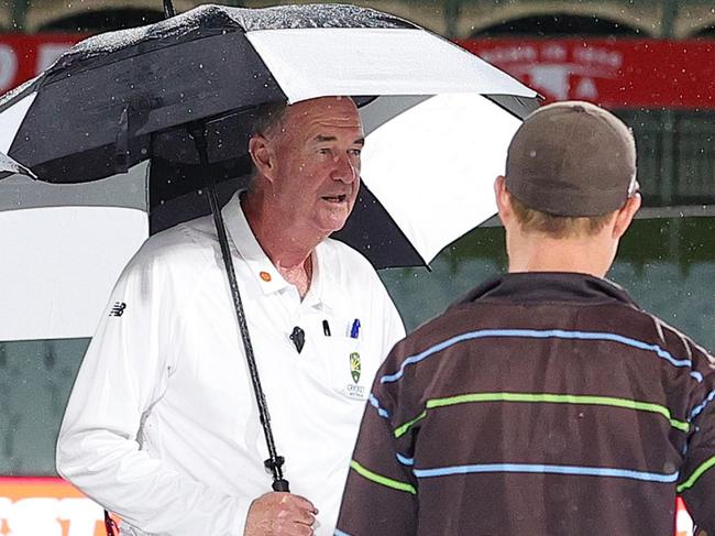 ADELAIDE, AUSTRALIA - NOVEMBER 26: Umpires Stephen Dionysius and Greg Davidson talk to Ground Staff to discuss the rain delay during the Sheffield Shield match between South Australia and Western Australia at Adelaide Oval, on November 26, 2024, in Adelaide, Australia. (Photo by Sarah Reed/Getty Images)