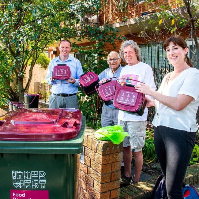 Inner West Mayor Darcy Byrne (left) holding up the purple food recycling bin with residents. Picture: Darcy Byrne (Facebook)