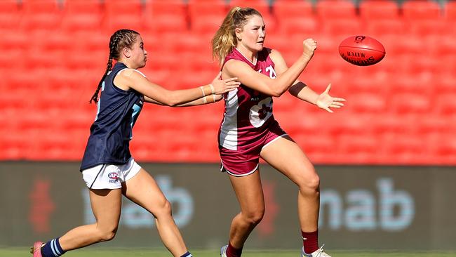 Alana Gee of Queensland handballs during the Under 18 Girls Championship match between Queensland and Vic Metro at Metricon Stadium. (Photo by Chris Hyde/AFL Photos)