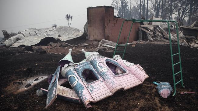 A melted children's play castle in the backyard of a burnt property at Cobargo. Picture Gary Ramage