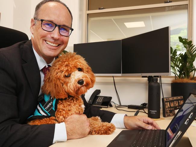 Emmanuel College principal Daniel Brown at his desk with wellness dog Mylo. Picture: Glenn Hampson.