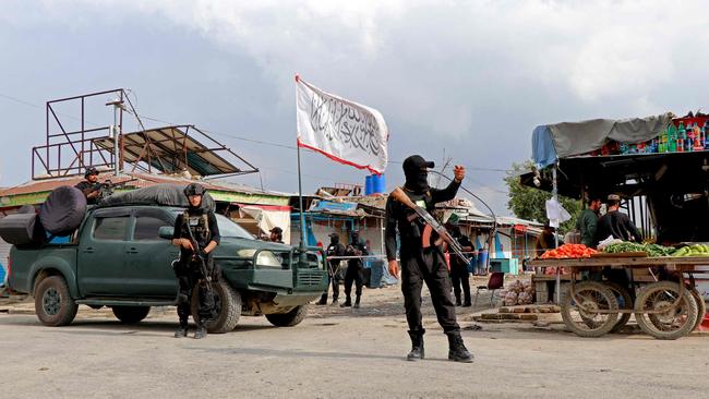 Taliban security personnel stand guard near the site of an explosion in Khost where three were killed.