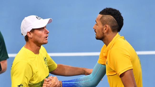 Australian team captain Lleyton Hewitt (left) is seen congratulating Nick Kyrgios (right) after winning his match against Jan-Lennard Struff of Germany during the World Group first round match of the Davis Cup between Australia and Germany played at Pat Rafter Arena in Brisbane, Friday, February 2, 2018. (AAP Image/Darren England) NO ARCHIVING, EDITORIAL USE ONLY