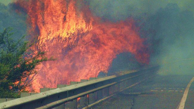 Huge flames during out-of-control bushfire at Phegans Bay on the Central Coast on January 1 2006. Picture: Bill O'Brien