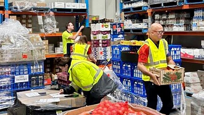 CEQ workers prepare to send stock from its Cairns warehouse to the ABIS supermarket in Kowanyama.