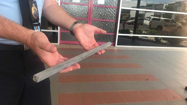 Darling Downs City Patrol Group Acting Inspector Matt Howard with one of the 50cm metal poles found near the incident scene where a Laidley Heights woman, 60, was impaled while driving west on the Warrego Highway near Oakey on Monday.