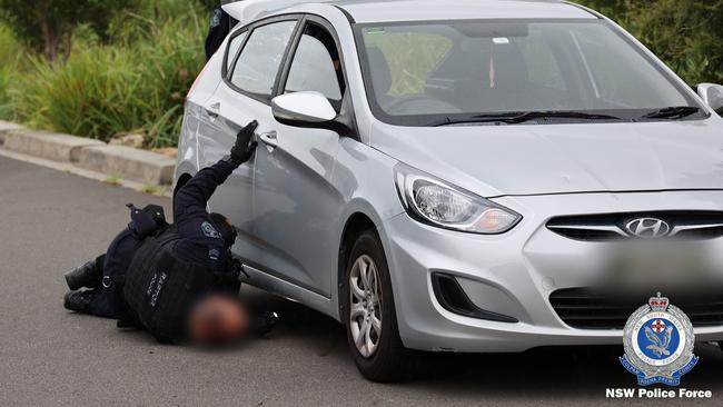 A Raptor Squad officer searches a vehicle amid an investigation into a public place shooting. Picture: NSW Police