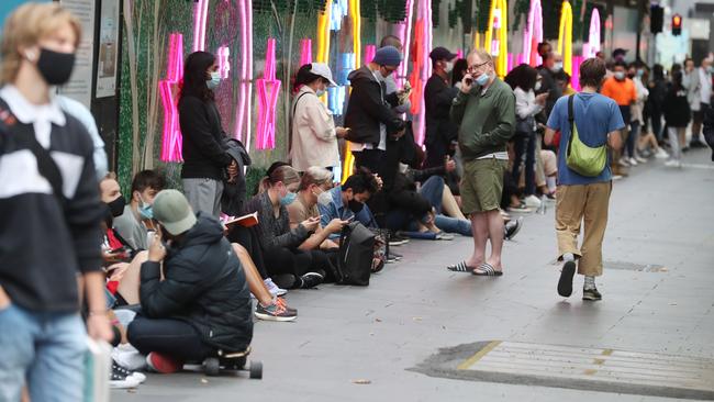 People line up on Swanston St to receive a Covid test. Picture: David Crosling