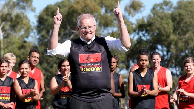 Prime Minister Scott Morrison plays football with students on a visit to Clontarf Aboriginal College in Perth yesterday. Picture: AAP