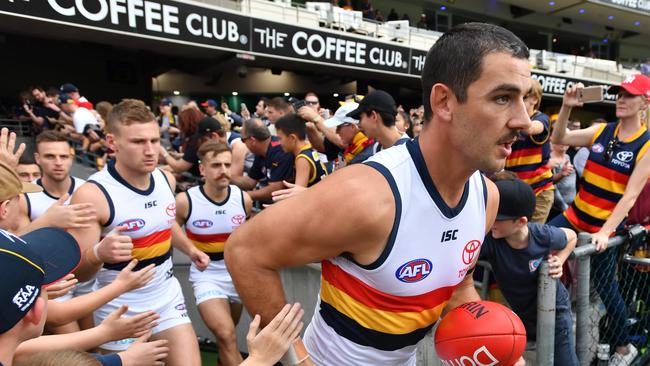 Taylor Walker leads the Crows onto the Gabba against Brisbane Lions a fortnight ago. Picture: AAP Image/Darren England