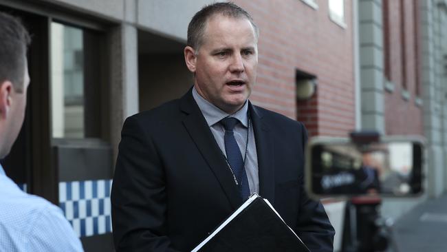 Detective Inspector Doug Rossiter outside Hobart Police Station on Sunday announcing the charges. Picture: LUKE BOWDEN