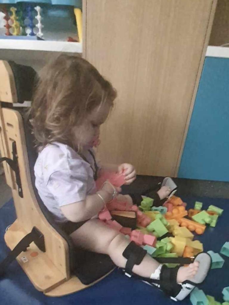 Samara using her support chair during her inpatient rehabilitation.