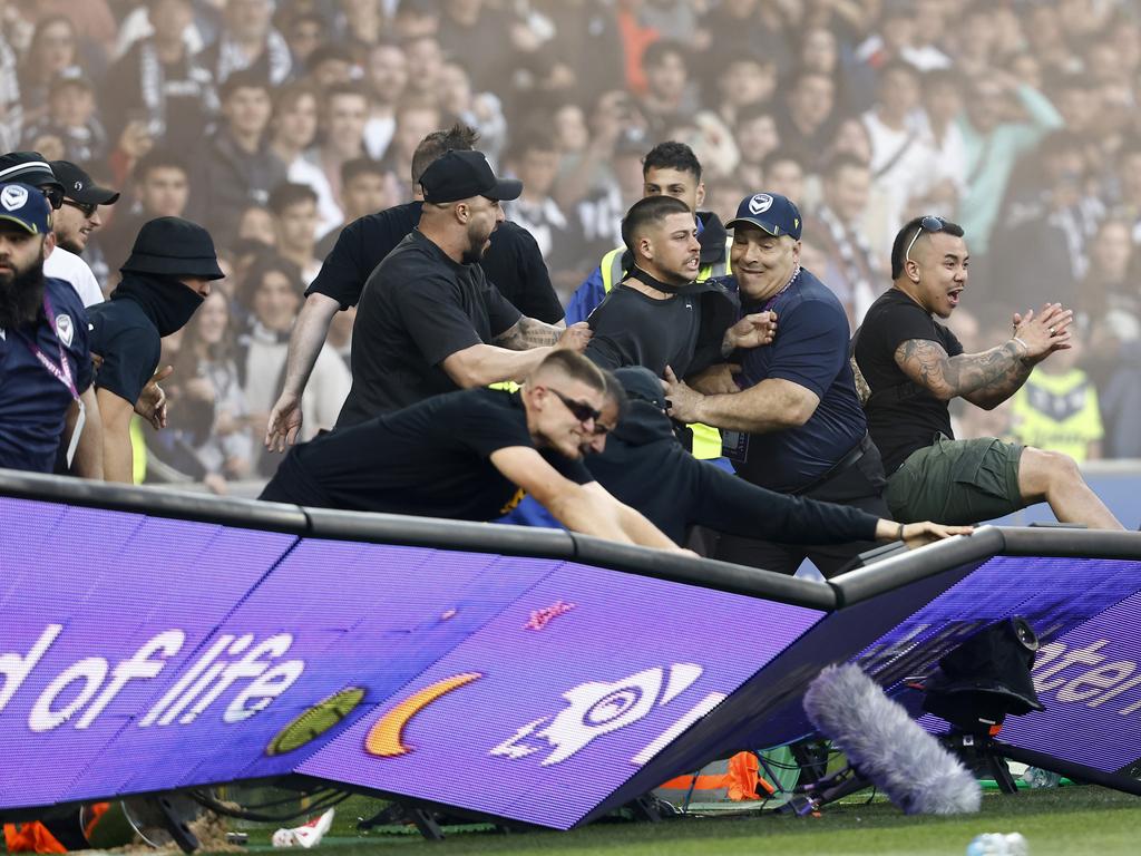 Fans storm the pitch at AAMI Park during the Melbourne derby. Picture: Darrian Traynor/Getty Images