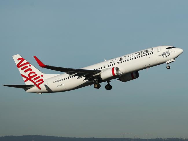 A Boeing Co. 737 aircraft operated by Virgin Australia Holdings Ltd. takes off from Sydney Airport in Sydney, Australia, on Thursday, Aug. 10, 2017. Virgin Australia said underlying performance for the first quarter of the 2018 financial year will improve from the year-earlier quarter. Photographer: Brendon Thorne/Bloomberg