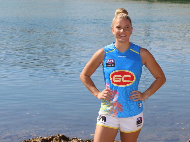 Gold Coast AFLW player Paige Parker reveals the Suns clash guernsey for the 2020 season, showing off its indigenous theme. Picture: Supplied.