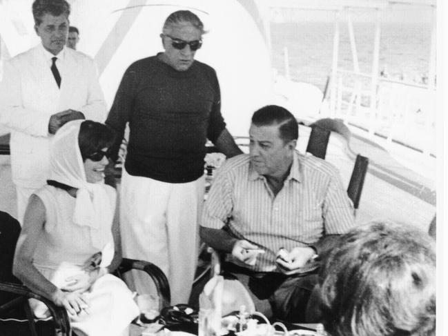 Aristotle Onassis hosts Jackie Kennedy (whose husband US president John F. Kennedy stayed behind in Washington DC) and Franklin Roosevelt Jr as they cruise the Mediterranean aboard his yacht, Christina, in 1963. Onassis married Jackie in 1968.