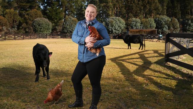 Emma Todd resort manager Ramada Resort Seven Mile Beach with Penny the chook. Ramada Resort Seven Mile Beach have diversified their guest offerings installing a hobby farm. Picture: NIKKI DAVIS-JONES