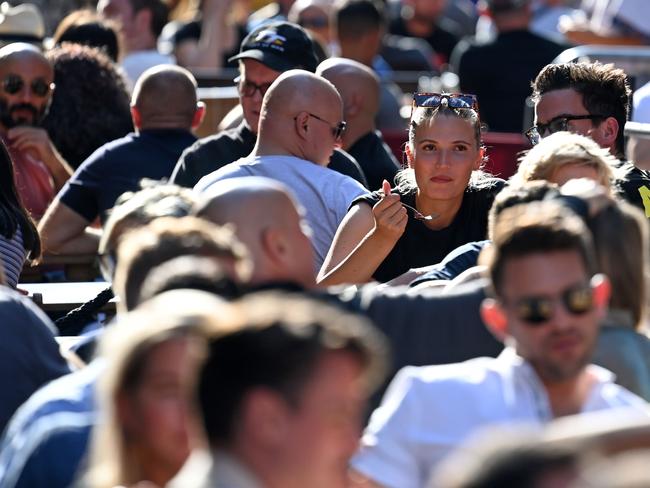 People take advantage of the September sun to eat outside in London. Picture: DANIEL LEAL-OLIVAS / AFP