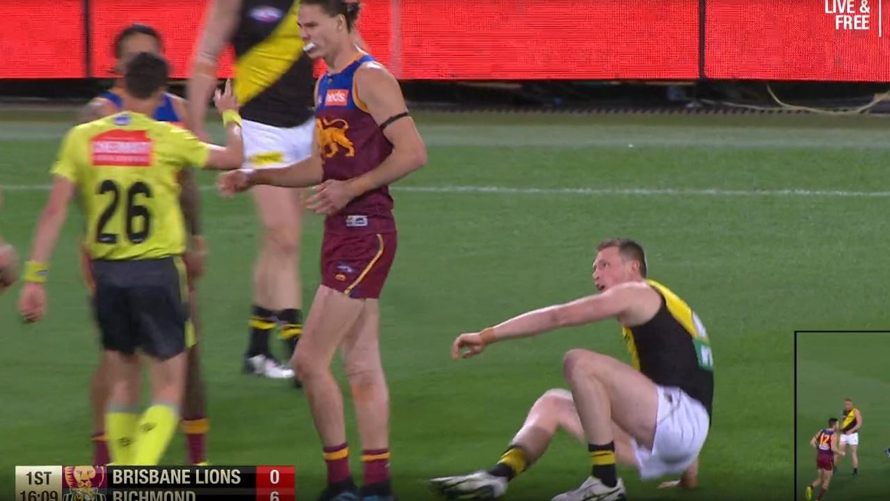 The umpire awards Dylan Grimes a free kick after being knocked over by Eric Hipwood.