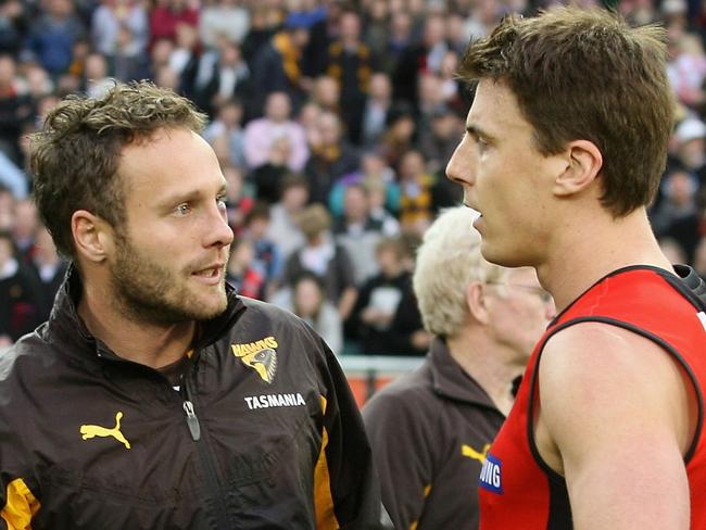 Hawthorn’s Brad Sewell chats with Essendon’s Matthew Lloyd post-match after the latter knocked the former out.