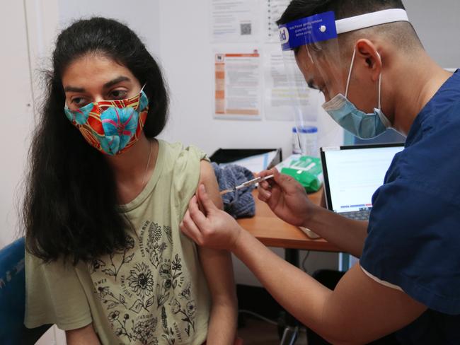 Nurse John Maya administers the Pfizer vaccine to a patient at St Vincent's Covid-19 clinic in Sydney. Picture: Lisa Maree Williams