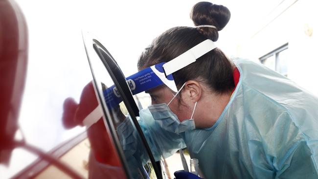 Medical professionals perform COVID testing at a drive through clinic in Ballarat