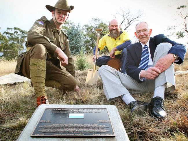 Friends of Soldiers Memorial Avenue committee member Peter Pickering, left, planting team leader Brett Balmforth, and Leslie Woolley, 75, of Hobart, pictured several years ago next to the new tree and plaque recognising the sacrifice of Private Ernest Charles Mawley Woolley who died of wounds receivedat Gallipoli in 1915.