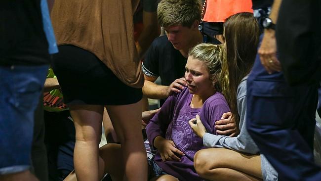 A woman is helped by friends after a fall. Pic: Lindsay Moller