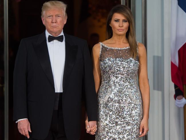 US President Donald Trump and First Lady Melania wait as they welcome French President Emmanuel Macron and his wife Brigitte for a State Dinner at the White House. Picture: Saul Loeb/AFP