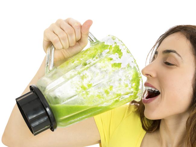 woman guzzling green smoothie generic image