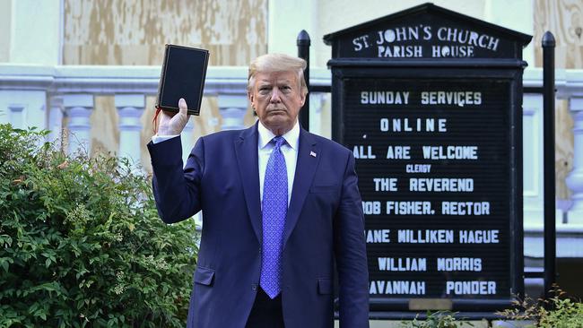 Donald Trump holds up a Bible outside St John's Episcopal church across Lafayette Park in Washington on June 1 last year. Picture: AFP