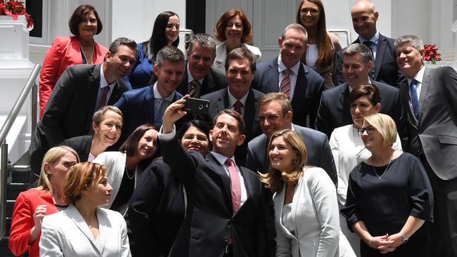 State Development Minister Cameron Dick (centre) takes a selfie with fellow ministers after the swearing in ceremony at Government House in Brisbane, Tuesday, December 12, 2017. Photo: AAP Image/Dan Peled