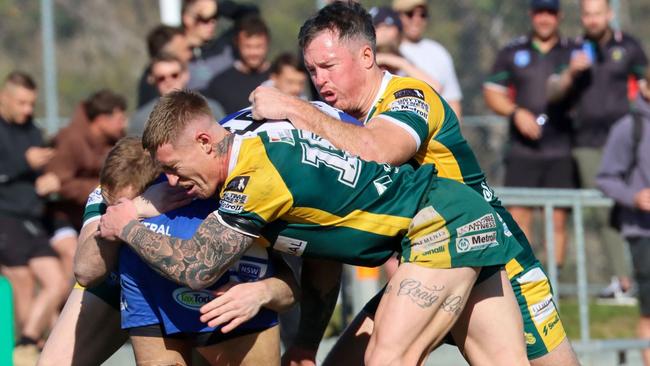 Macquarie's Connor Kirkwood and Liam Higgins tackle a Central Newcastle player during the Scorpions' elimination final win at St John Oval, Charlestown, on August 20, 2022. Photo: Jenny Sharkey Pead