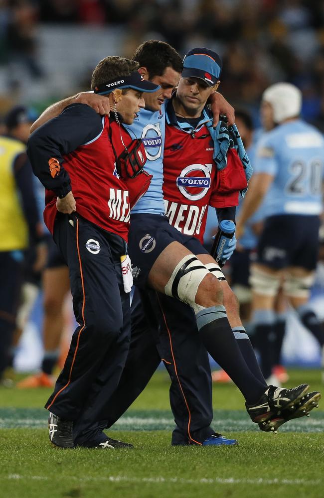 Dave Dennis is helped off the pitch by medical staff at Allianz Stadium after injuring a knee ligament.