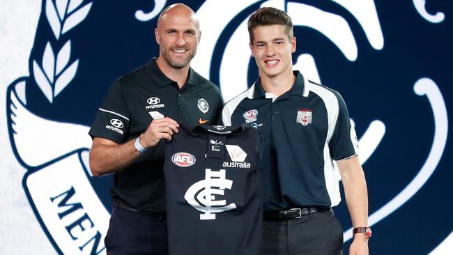 Liam Stocker receives his Carlton guernsey from Chris Judd minutes after the blockbuster trade went down. Picture: Getty