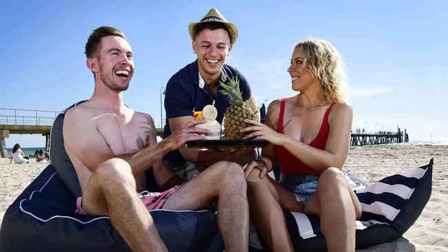 Kris Ball serves up cocktails to Riley Marshall and Mel Paxton ahead of the Moseley Beach Club's return last summer. Picture: Bianca De Marchi