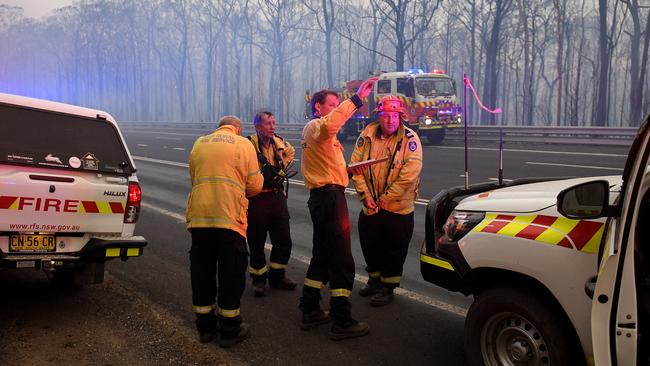 RFS captains discuss plans as the Gospers Mountain fire impacts Bilpin on December 21, 2019, with temperatures tipping 40 degrees. Picture: AAP Image/Dan Himbrechts